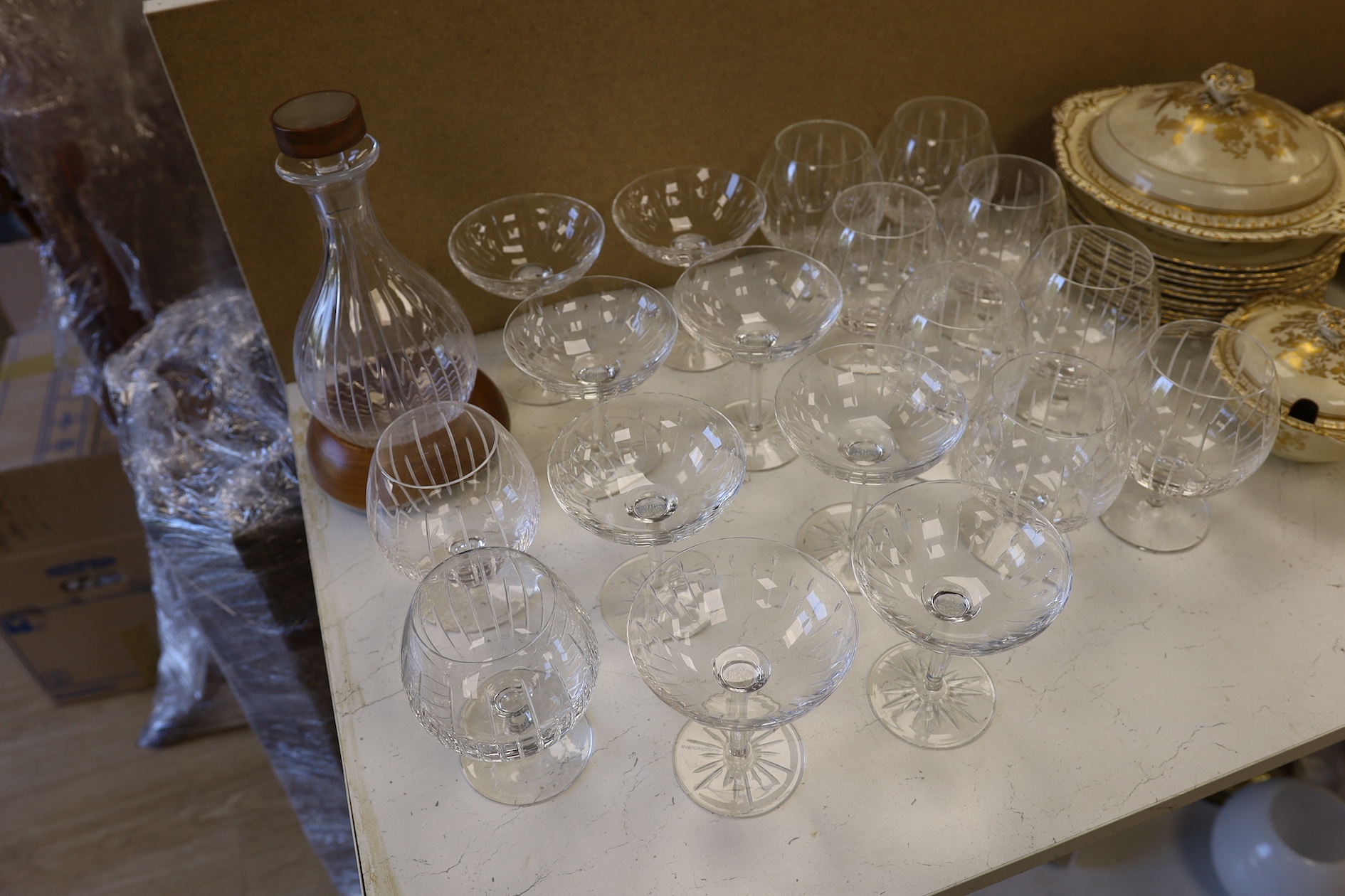 A Linley Glyndebourne pattern cut glass decanter with a silver mounted stopper, on a weighted wooden coaster stand, and a matching set of ten goblets, and eight champagne coupes, largest 30cm high. Condition - all in ver